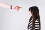 crop-hand-pointing-at-upset-girl_23-2147798382