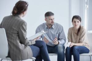 Family therapist during meeting with unhappy, married couple